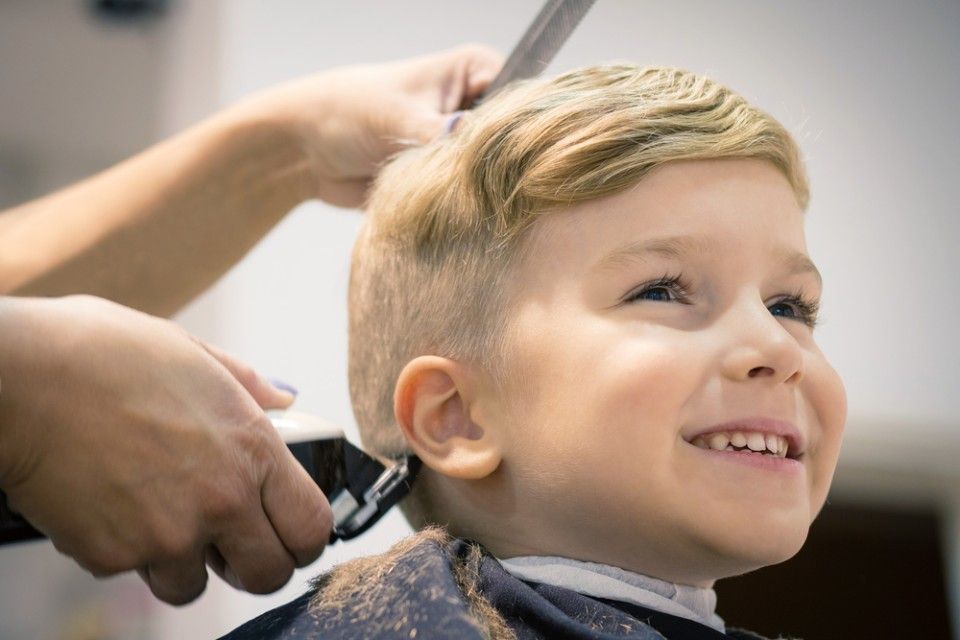 Lapsi hiustenleikkuussa parturi-kampaamossa